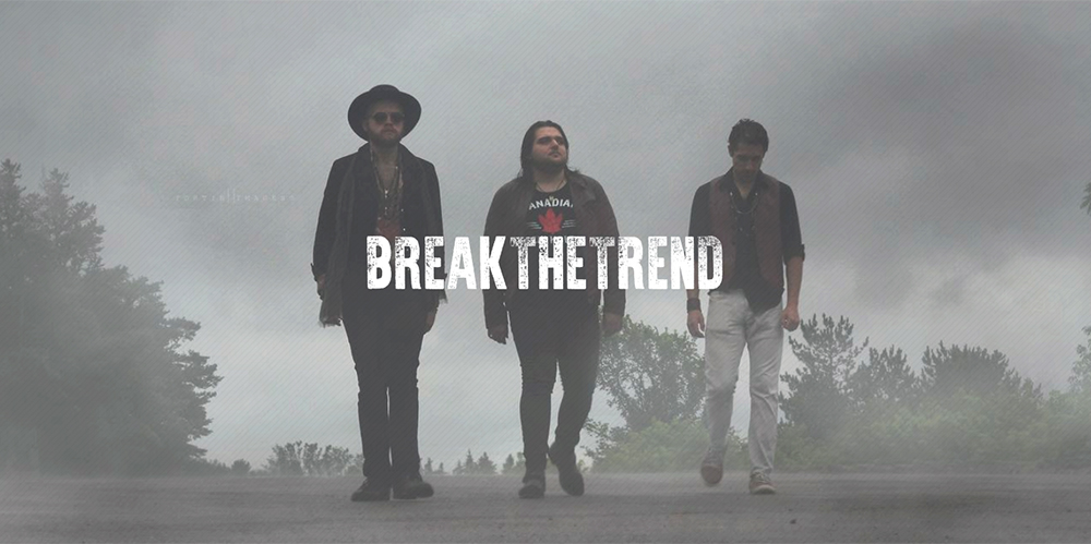 Break the Trend band walking down the road on a foggy day