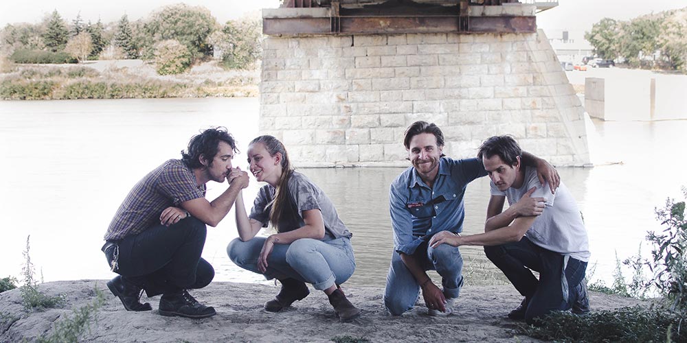 R U S T O W L Crooked Teeth Premiere Image with the band under the bridge